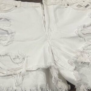 Free People white 5 pocket distressed shorts . Size 32 waist 100% cotton .